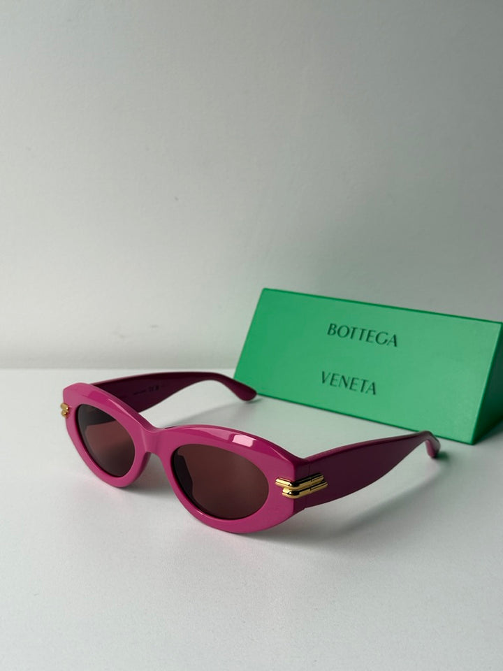 Pink Bottega Veneta BV1322S sunglasses, angled view with dark lenses
