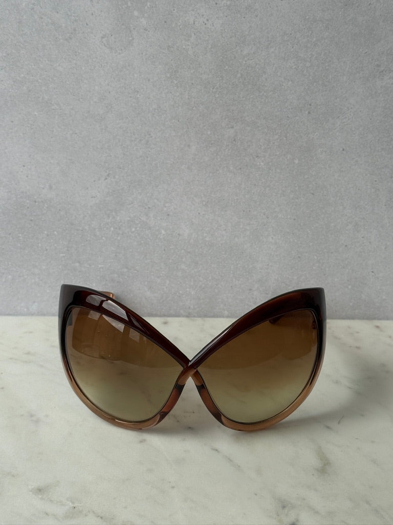 Front view of oversized brown mask sunglasses with curved gradient lenses