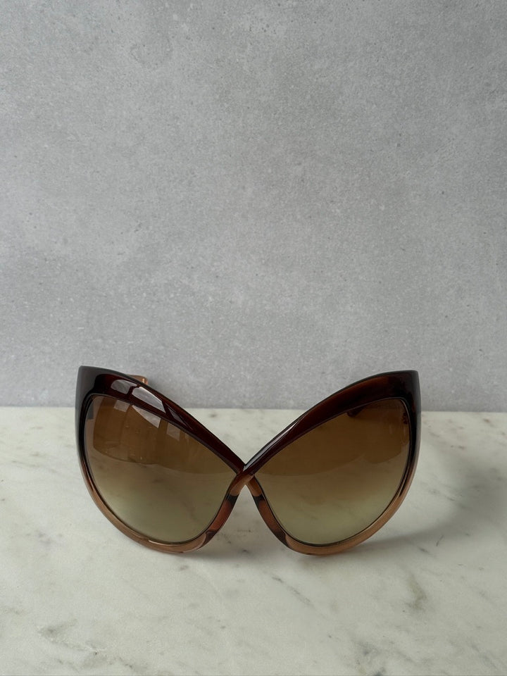 Front view of oversized brown mask sunglasses with curved gradient lenses