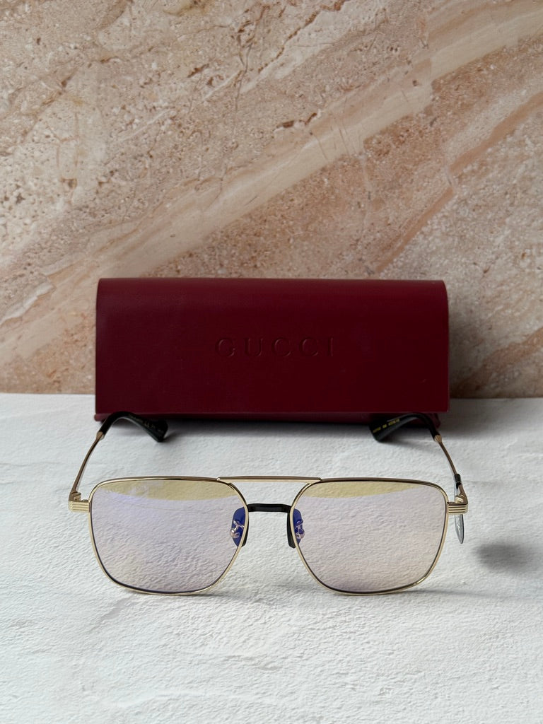 Gucci gold metal pilot sunglasses with photochromic lenses and black nose bridge accents