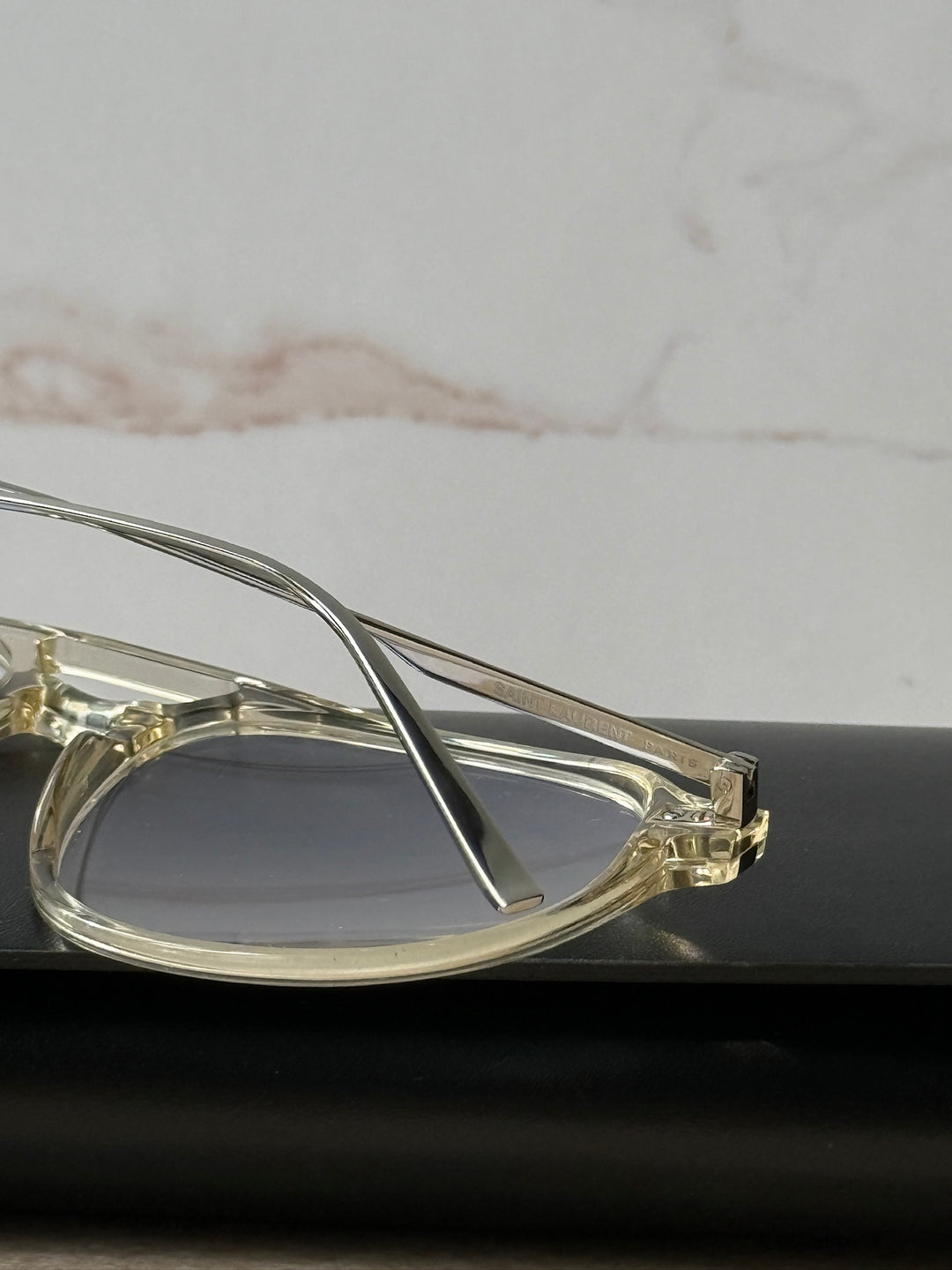 Close-up clear aviator eyeglass frame hinge and lens edge