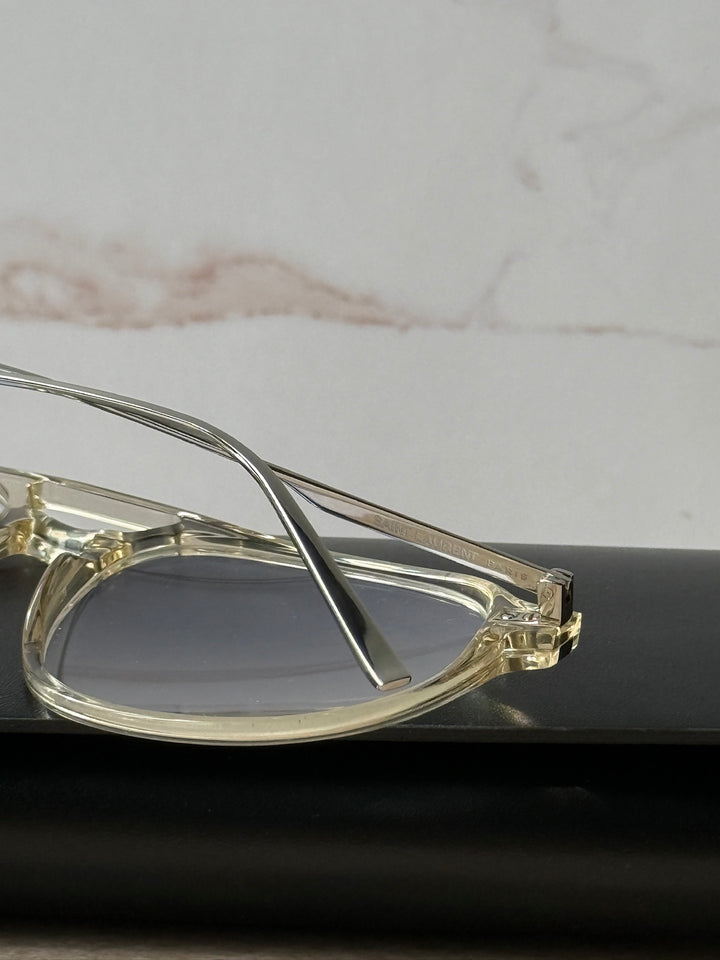 Close-up clear aviator eyeglass frame hinge and lens edge