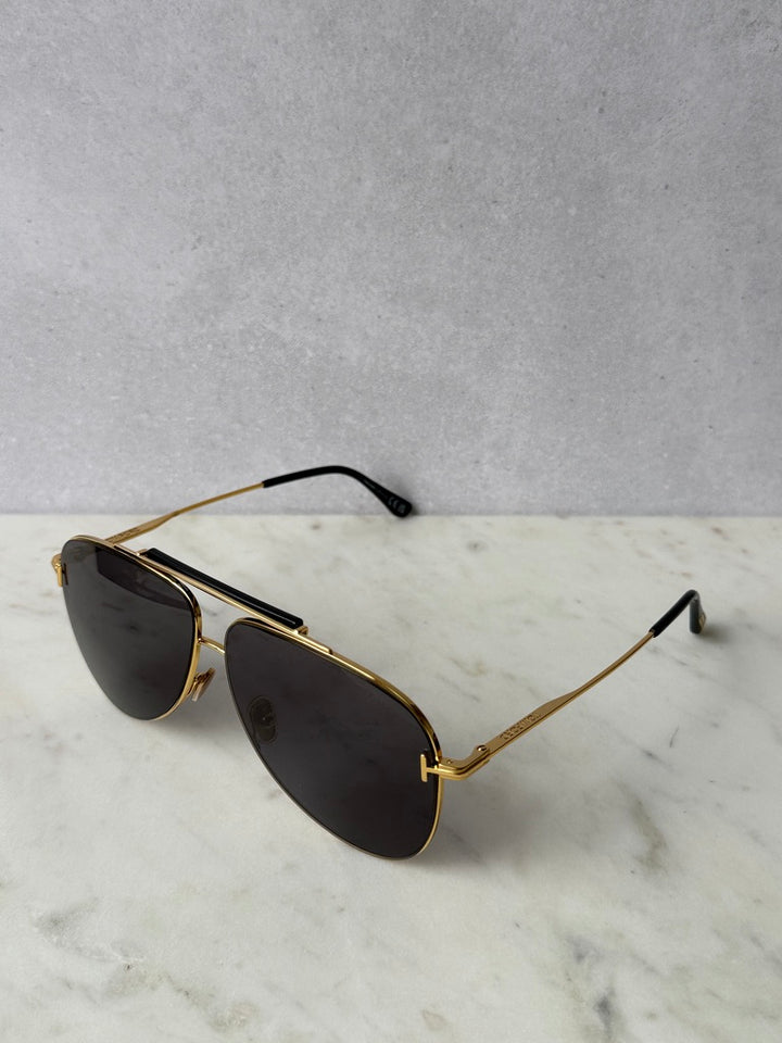 Gold aviator sunglasses with dark lenses, front-left angle
