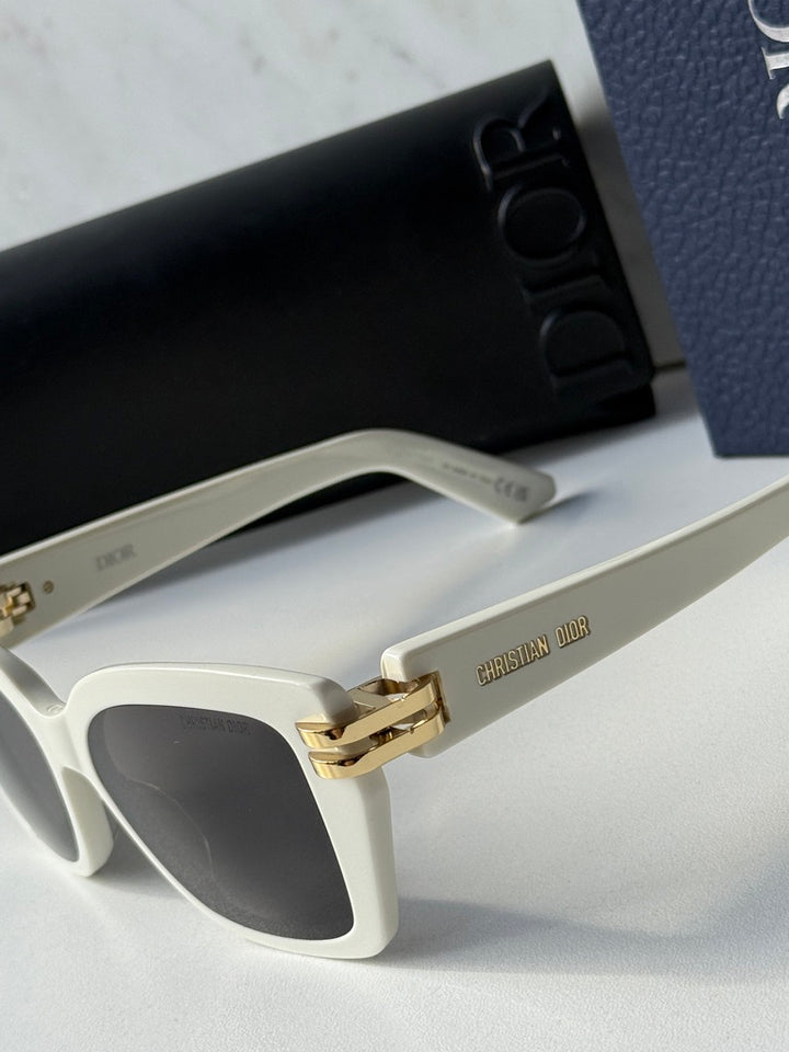Oversized butterfly sunglasses: white temples with gold hinge and dark lenses