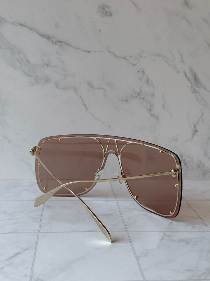 Oversized shield sunglasses in nude with brown lenses and gold metal frame details