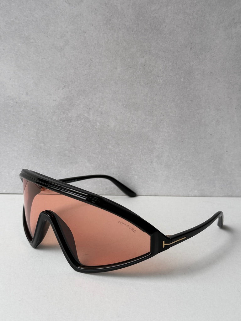 Black angular sunglasses with orange-tinted lenses, side view