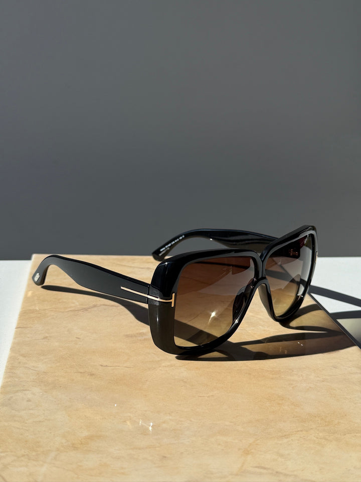 Black square sunglasses side view with brown-tinted lenses and thick frame
