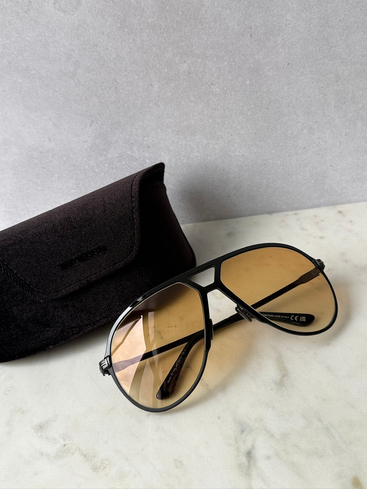 Oversized black aviator sunglasses with amber gradient lenses and black frame