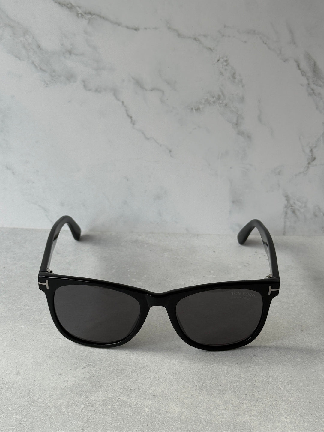 Black sunglasses with dark polarized lenses and curved temples
