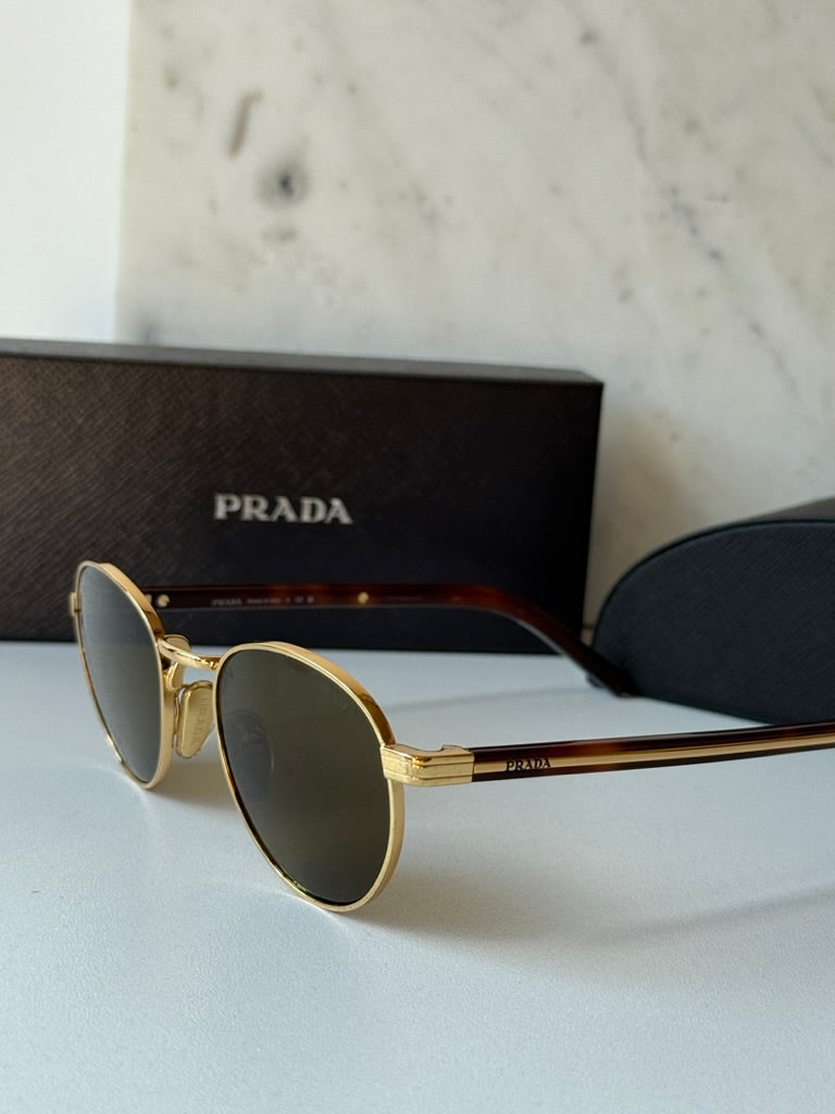 Prada round sunglasses with gold frame and dark brown mirrored lenses, side three-quarter view