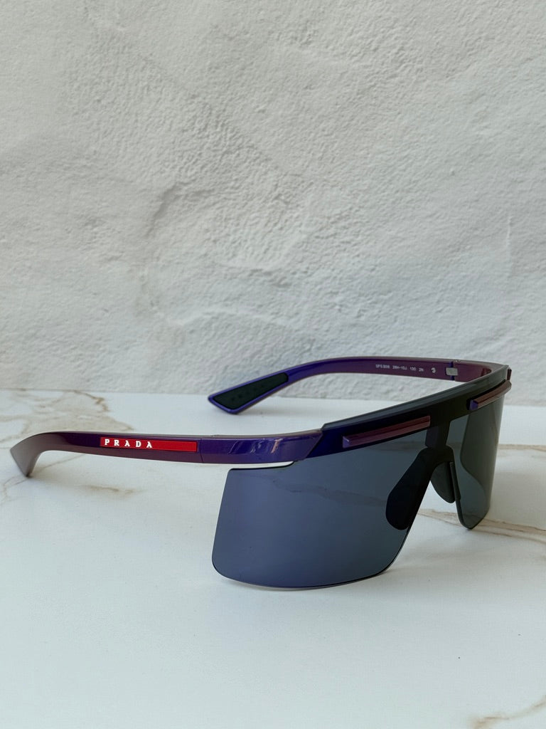 Purple Prada Sport PS sunglasses with dark mirrored lenses and rectangular brow bar