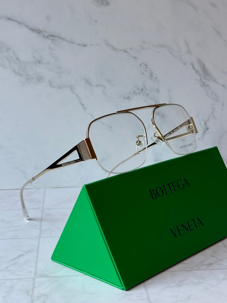 Gold-tone aviator eyeglass frames with clear lenses and metal temples