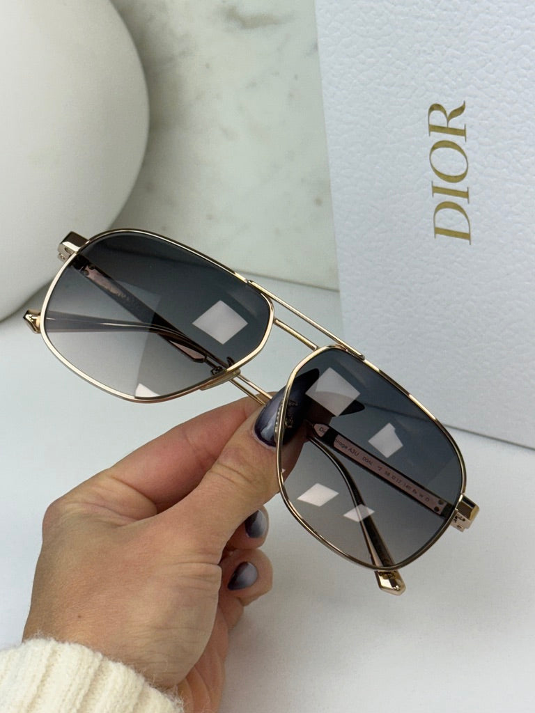 Dior aviator sunglasses with rose gold metal frames and dark gray lenses, side detail