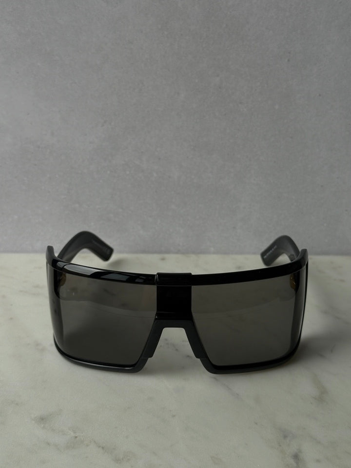 Black mask-style sunglasses with dark tinted rectangular lenses