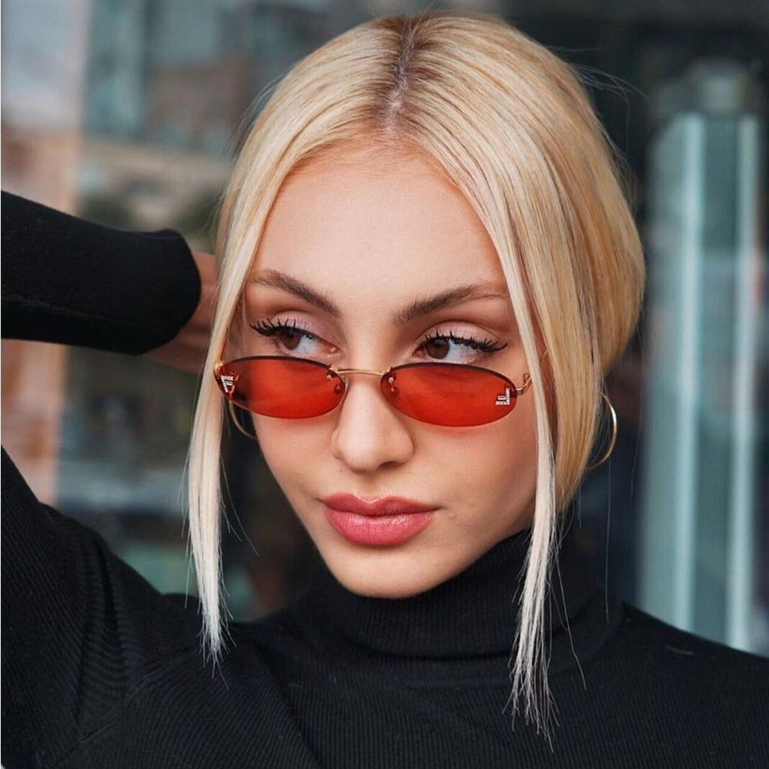 Gold thin-frame round sunglasses with red tinted lenses on model