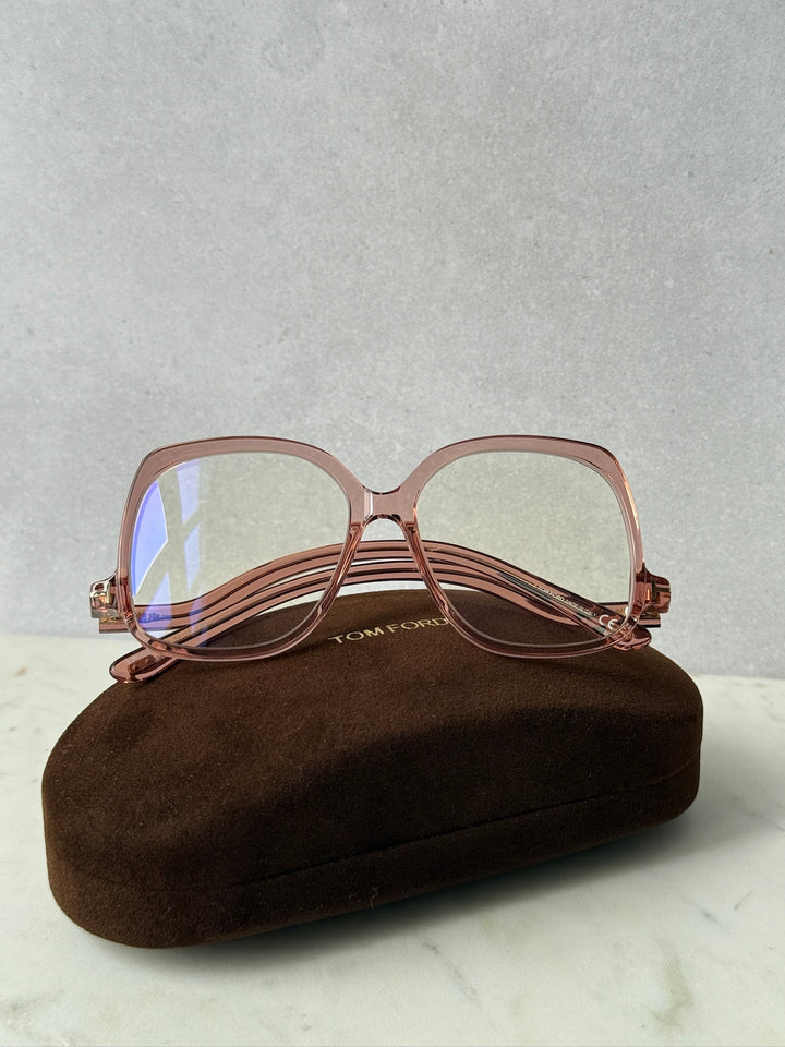 Pink oversized blue-light glasses frames, front view with blue-tinted lenses