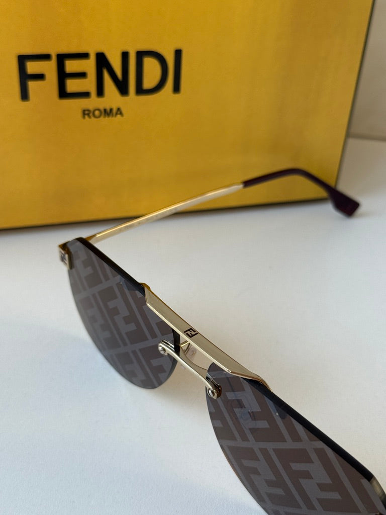 Side view of gold aviator sunglasses with brown FF-pattern lenses and Fendi FF emblem