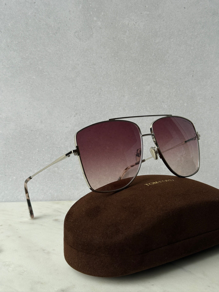 Aviator sunglasses with maroon gradient lenses, thin metal frame, and nose pads