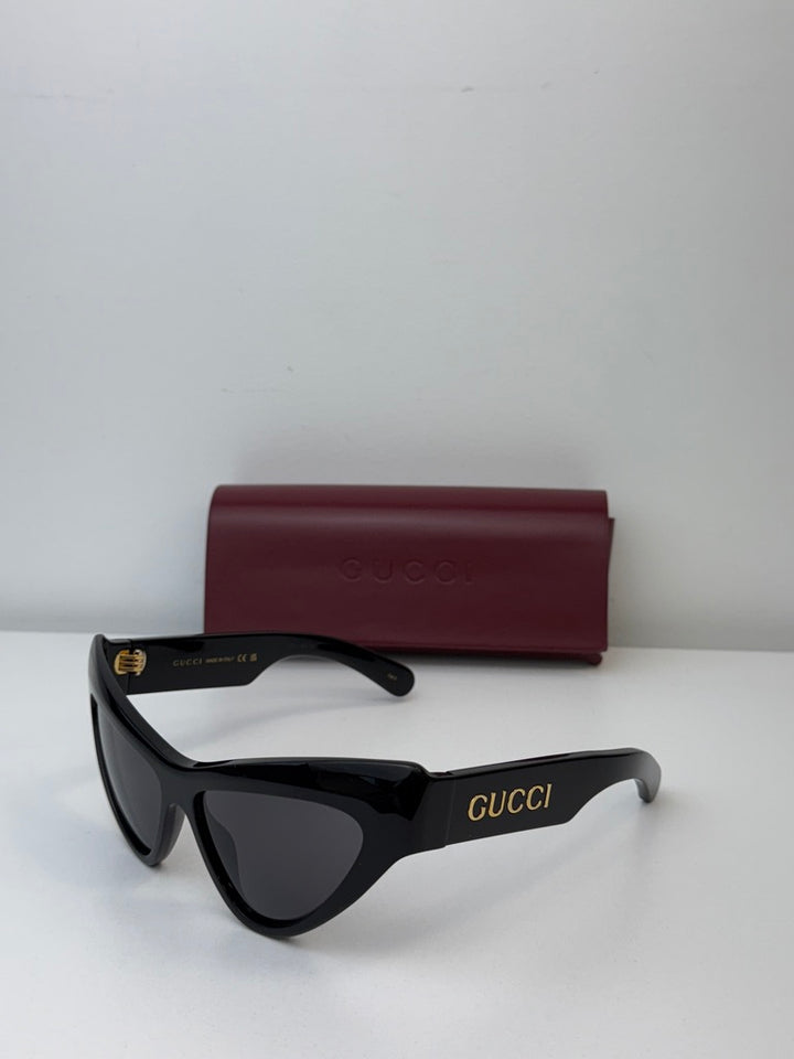 Gucci black cat-eye sunglasses with dark lenses and burgundy case
