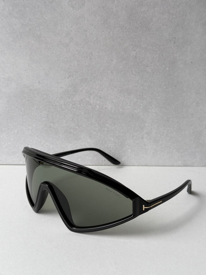 Black angular sunglasses with dark green lenses and slim arms