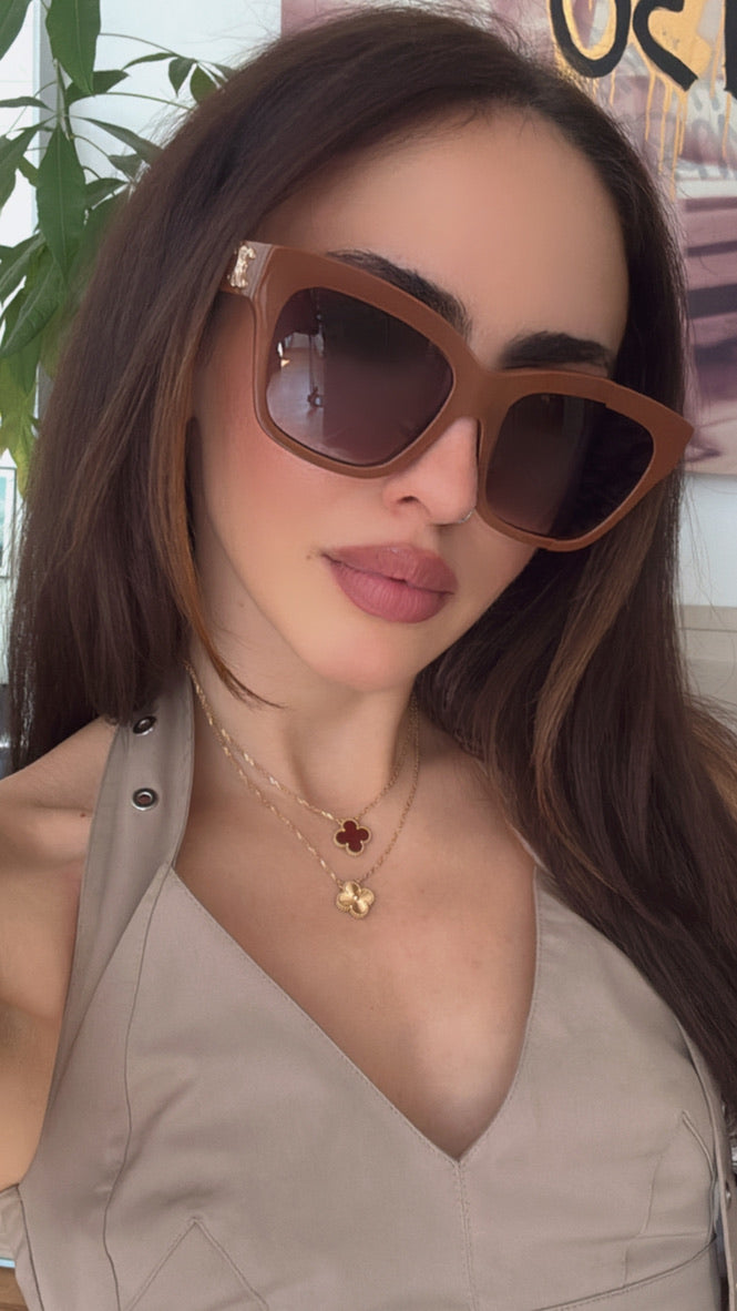 Celine brown cat-eye sunglasses worn by model, dark green lenses and gold logo