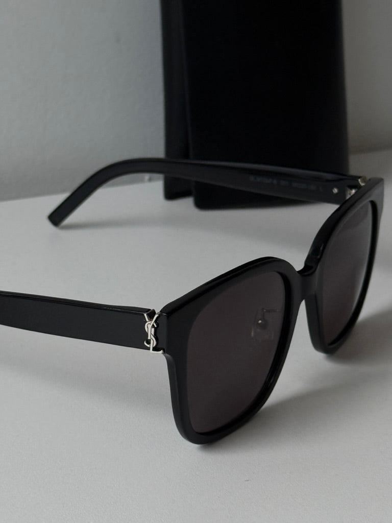 Saint Laurent black cat-eye sunglasses side view with dark lenses and metal hinge