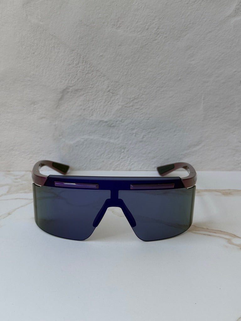 Purple Prada Sport PS sunglasses with dark shield lenses and curved temple arms