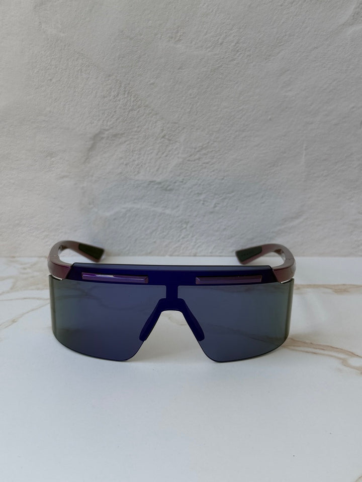 Purple Prada Sport PS sunglasses with dark shield lenses and curved temple arms