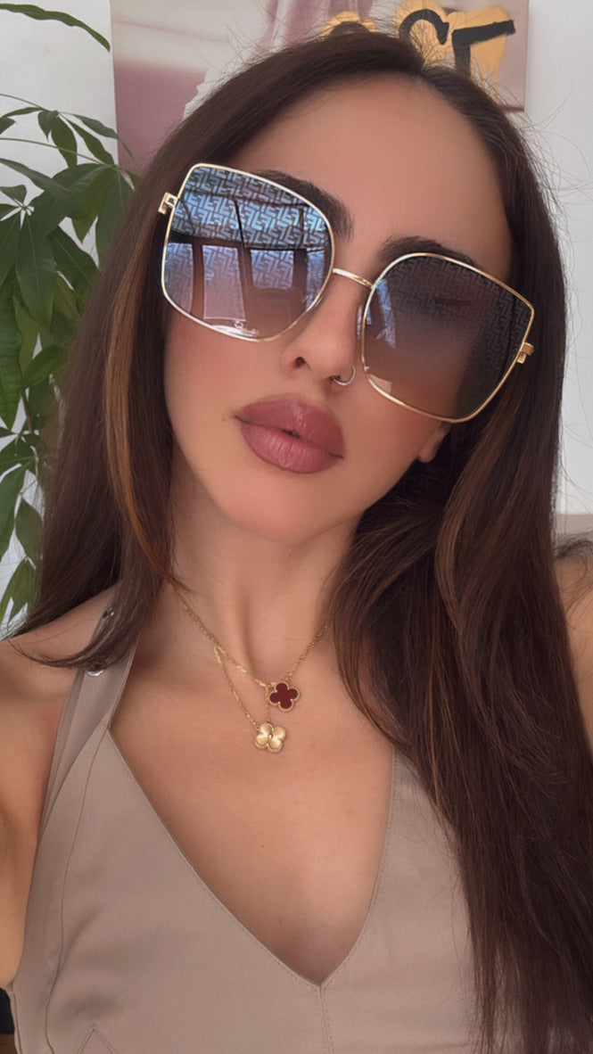 Fendi gold mirror sunglasses on model, square cat-eye lenses with monogram detail