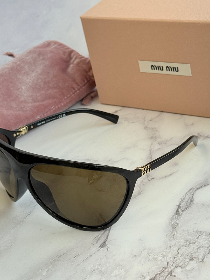 Black shield sunglasses with brown lenses and gold-tone logo on the temple.