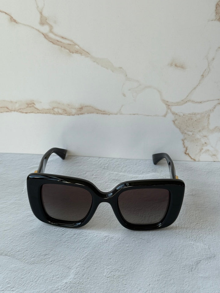 Gucci GG1975S thick cat-eye sunglasses, black frame with tinted gray lenses