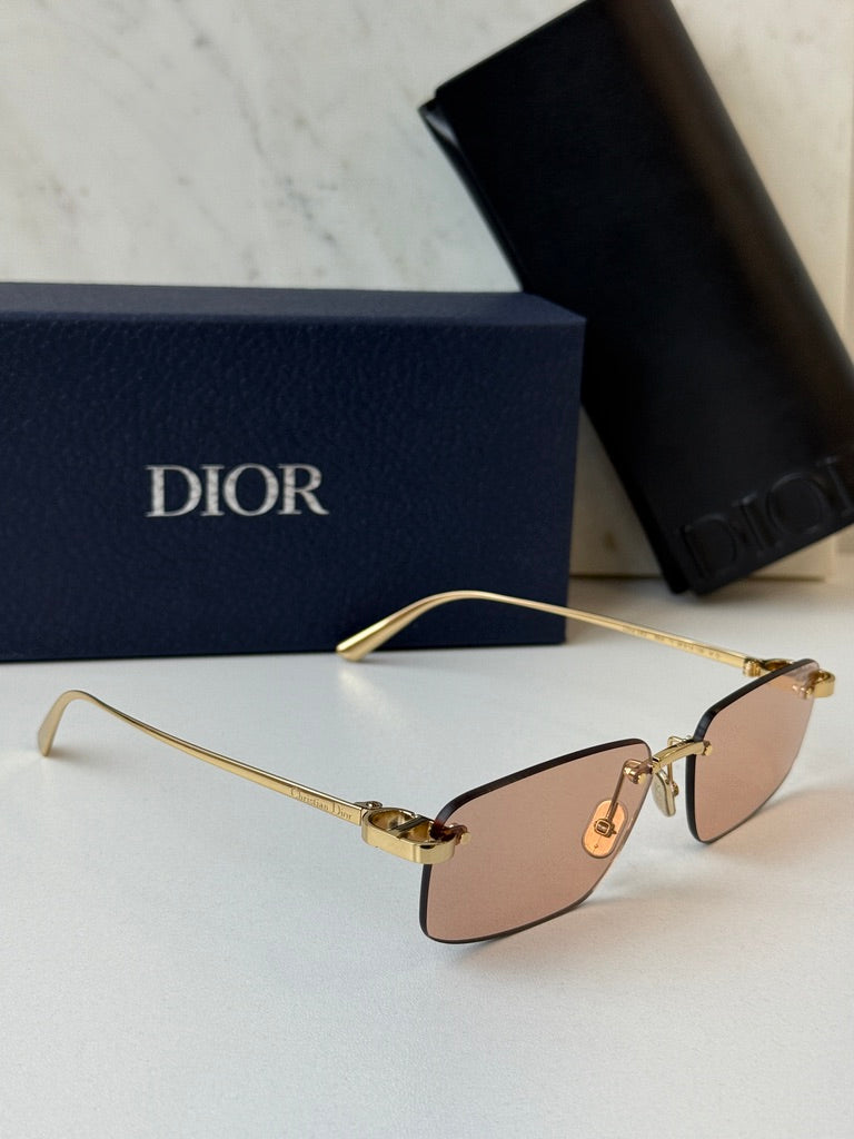 Dior rimless sunglasses side view, tinted pink lenses and gold-tone frame