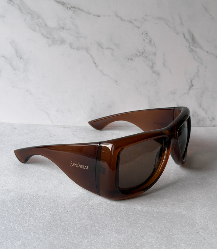 Brown Howl sunglasses with dark lenses and engraved logo on temple.