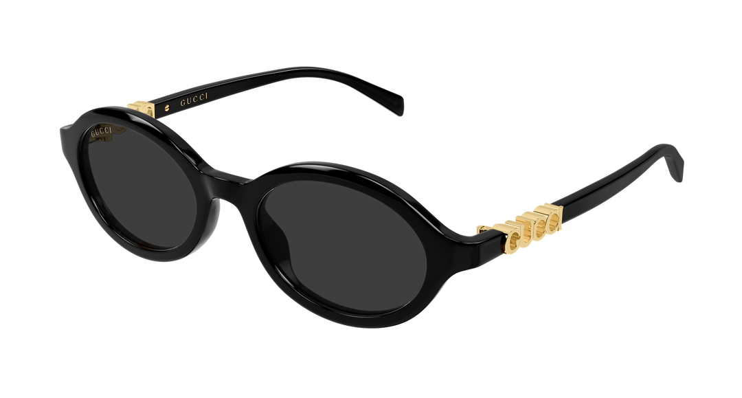 Black oval sunglasses with dark lenses and GUCCI gold logo on temples