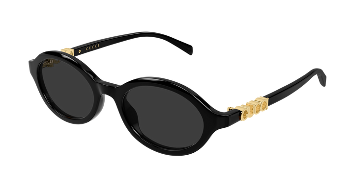 Black oval sunglasses with dark lenses and GUCCI gold logo on temples