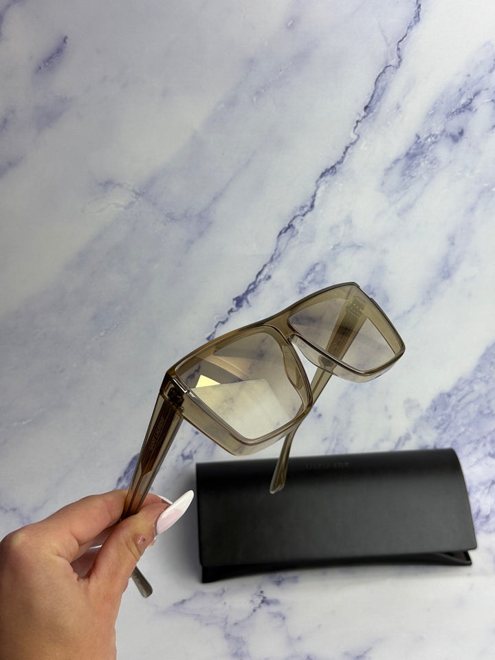 Beige flat-top sunglasses with light-tinted lenses and logo on the temple
