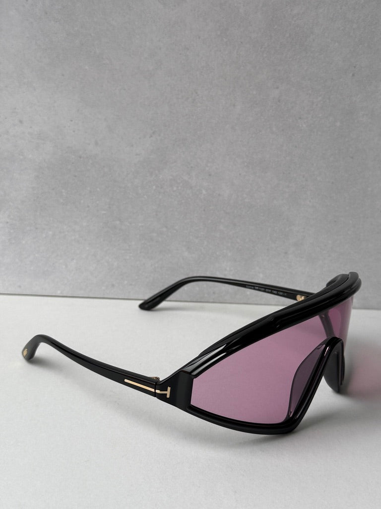 Black sunglasses with pink-tinted lenses and gold-tone temple details