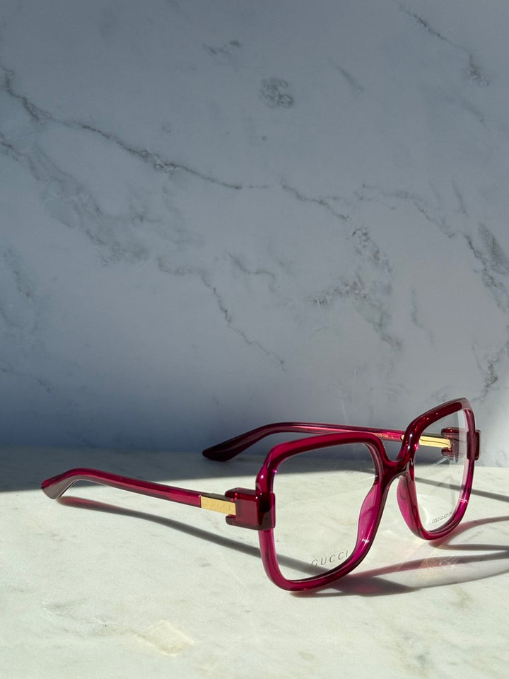 Pink red oversized square eyeglasses side profile with clear lens and temple text