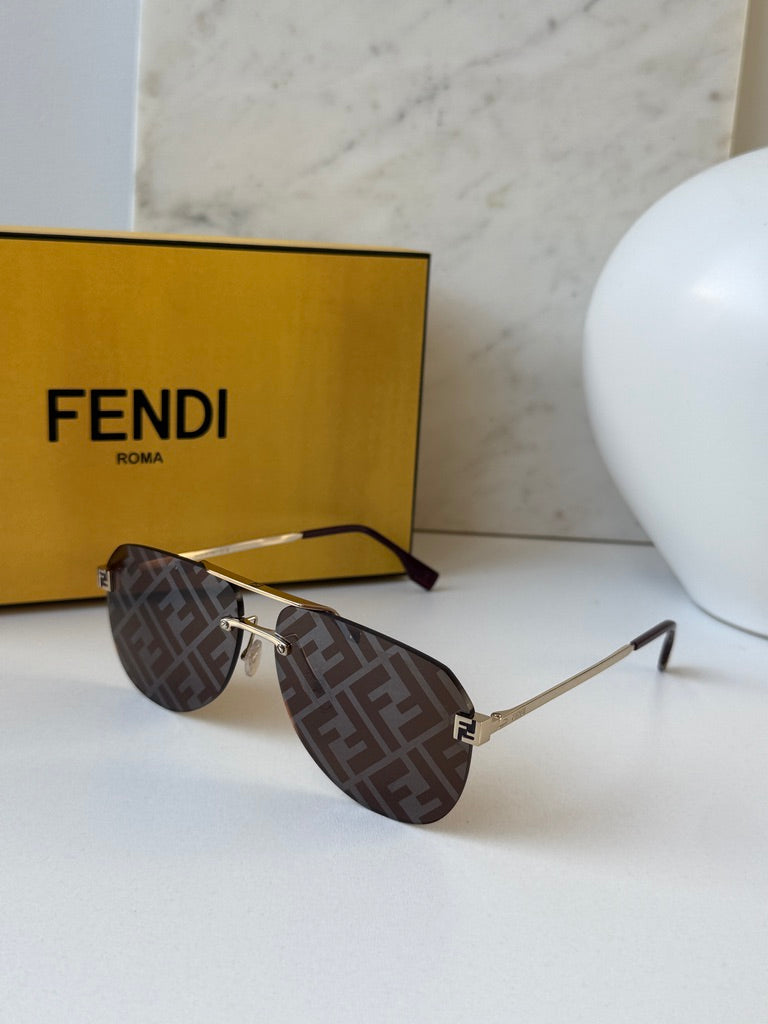 Aviator sunglasses with brown FF-pattern lenses, gold frame hardware, and Fendi FF emblem