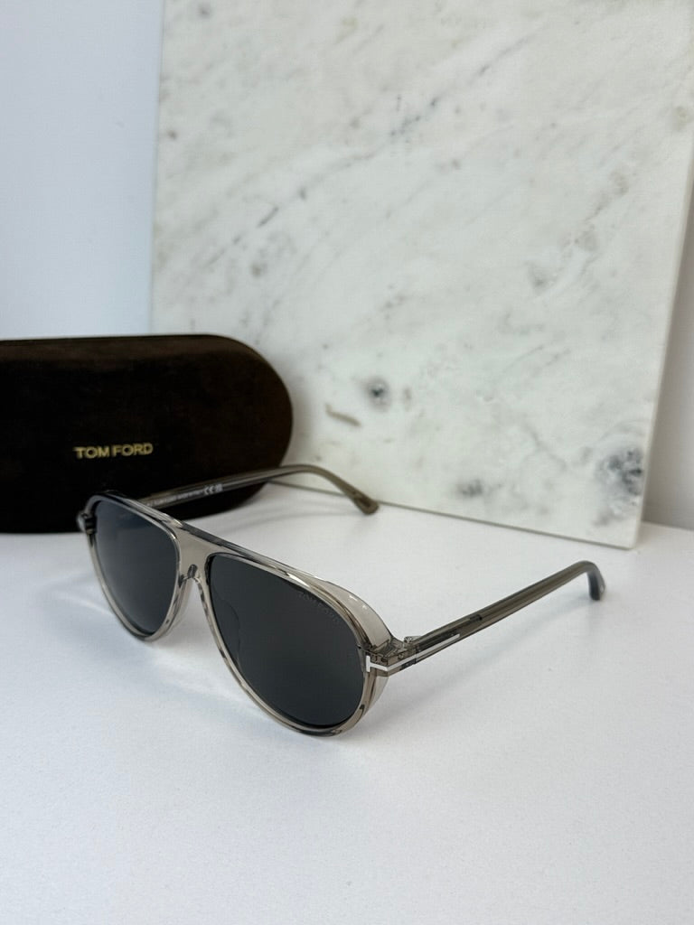 Aviator sunglasses with dark lenses and silver frame, lens-side view