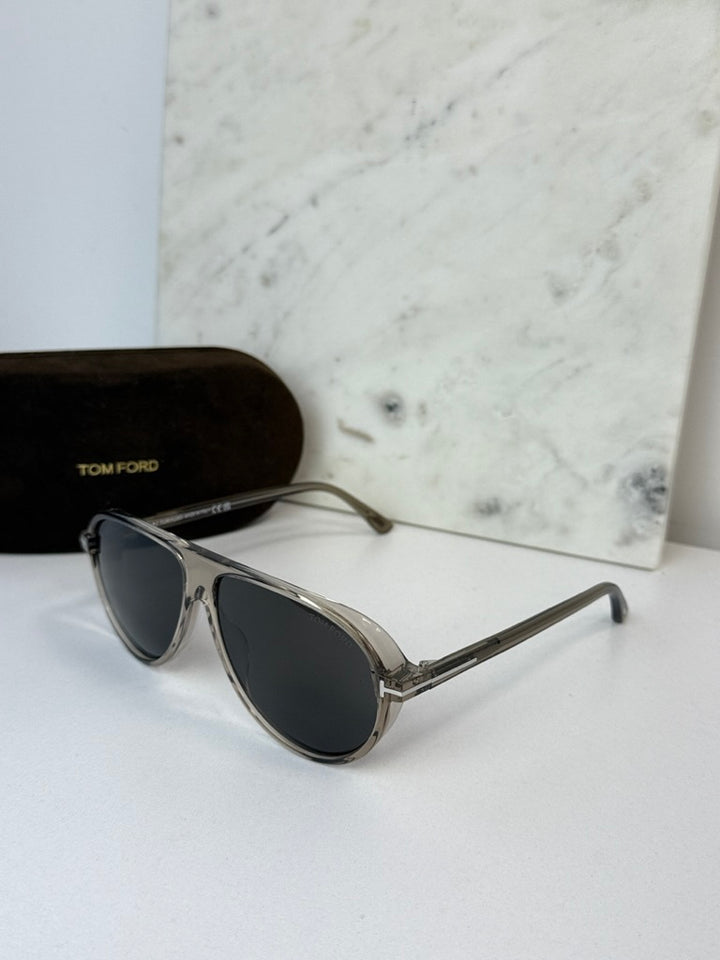 Aviator sunglasses with dark lenses and silver frame, lens-side view