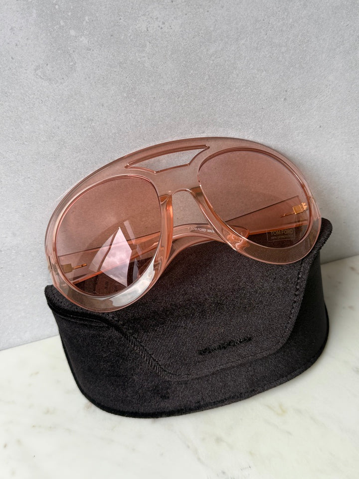 Oversized pink mask sunglasses with tinted lenses, in black fabric pouch