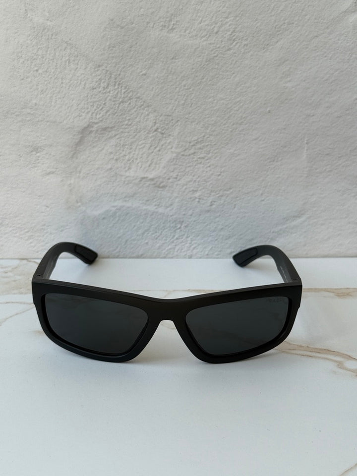 Black Prada Sport sunglasses with dark lenses and wide square frames