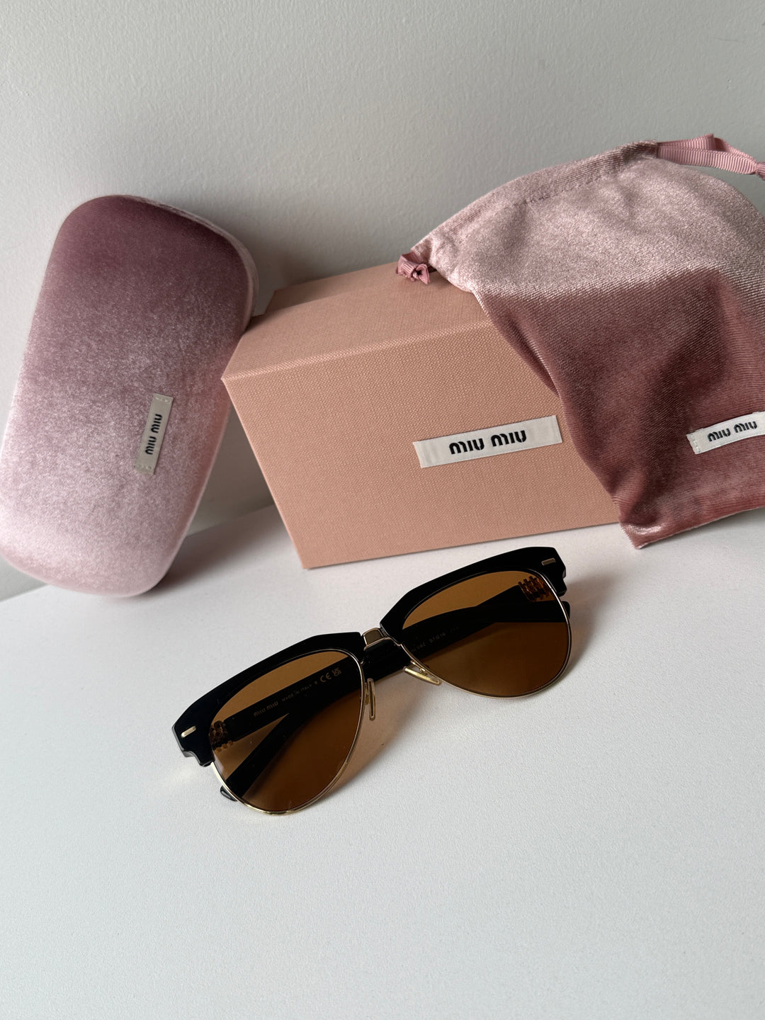 Miu Miu cat-eye sunglasses with brown lenses with dust bag, box, and pink cloth