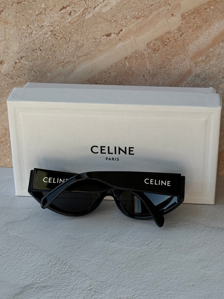 Black cat-eye sunglasses with dark lenses and Celine logo, with eyeglass case