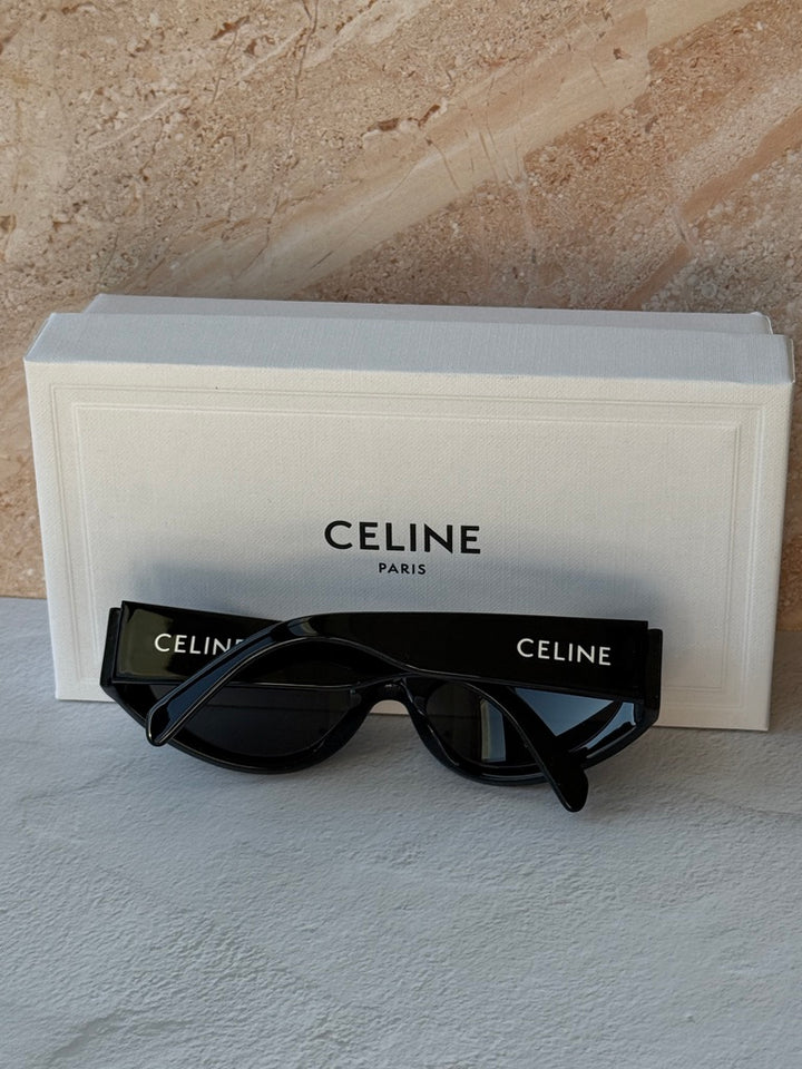 Black cat-eye sunglasses with dark lenses and Celine logo, with eyeglass case
