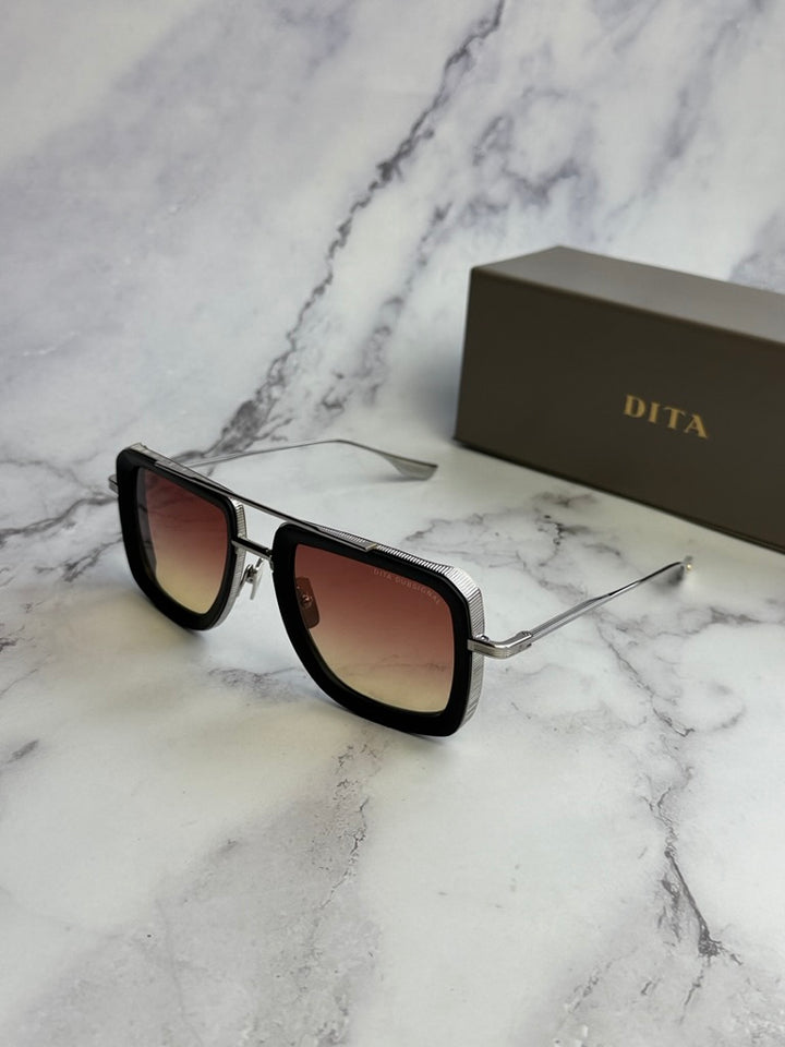 Aviator sunglasses with black frame and rose gradient lenses, metal bridge, tilted view