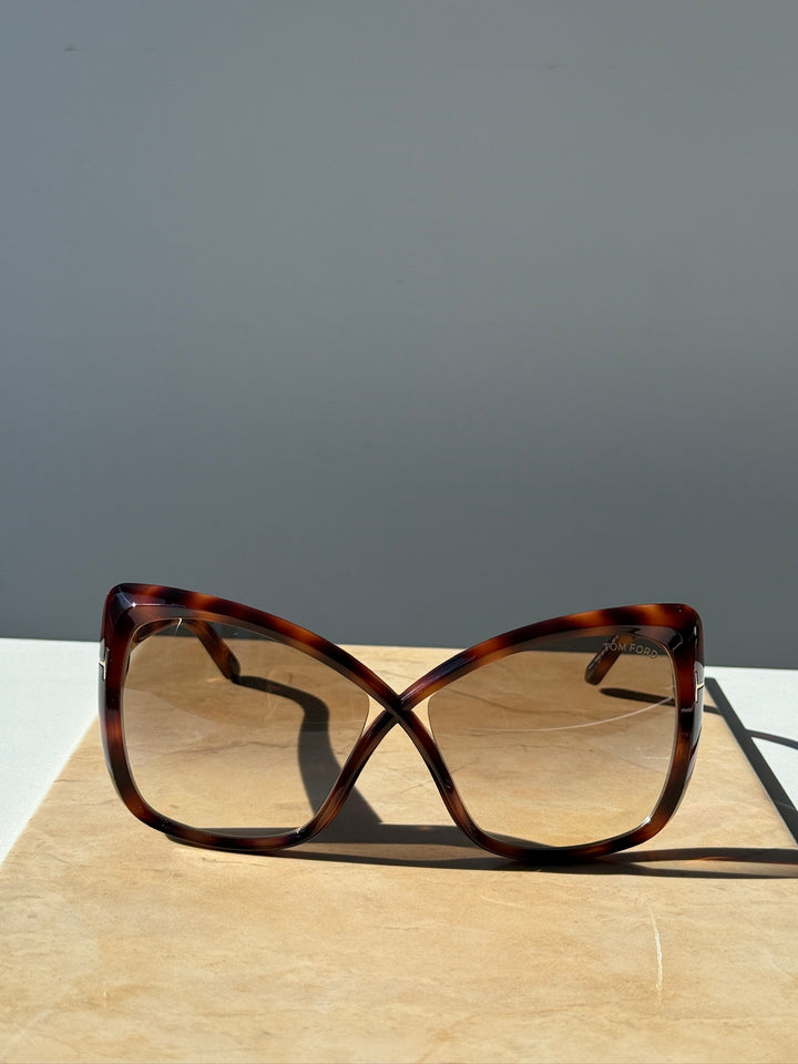 Oversized cat-eye sunglasses, Havana brown frame with amber-tinted lenses, side view