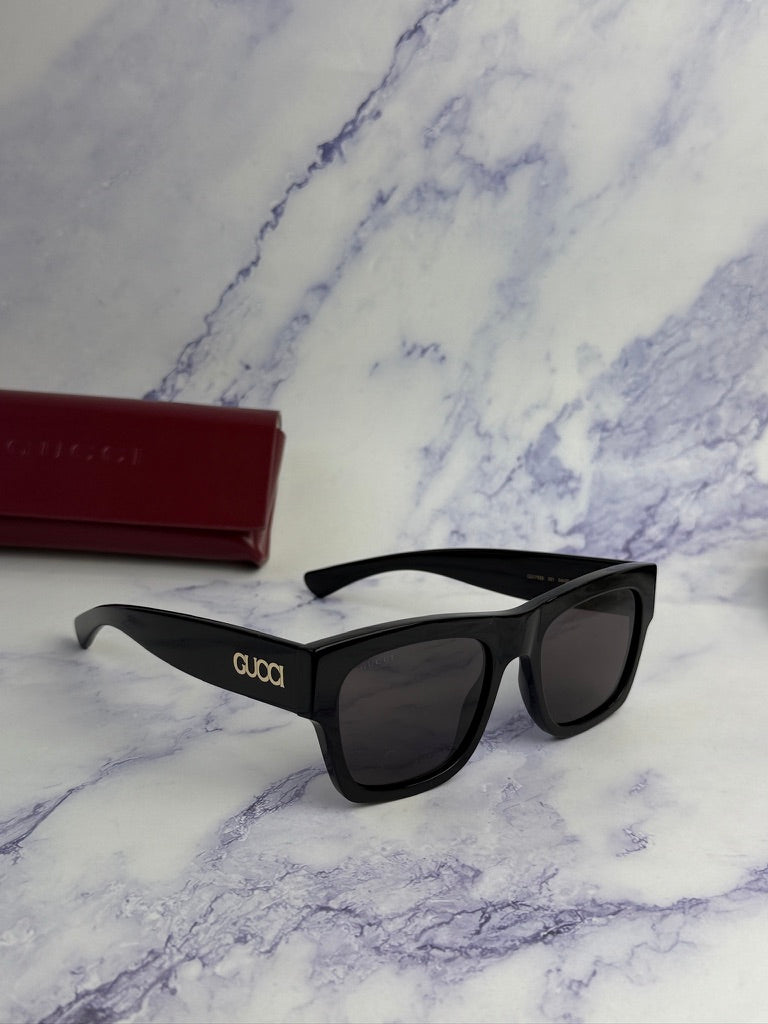 Black Gucci sunglasses, angled side view with GG logo on temple