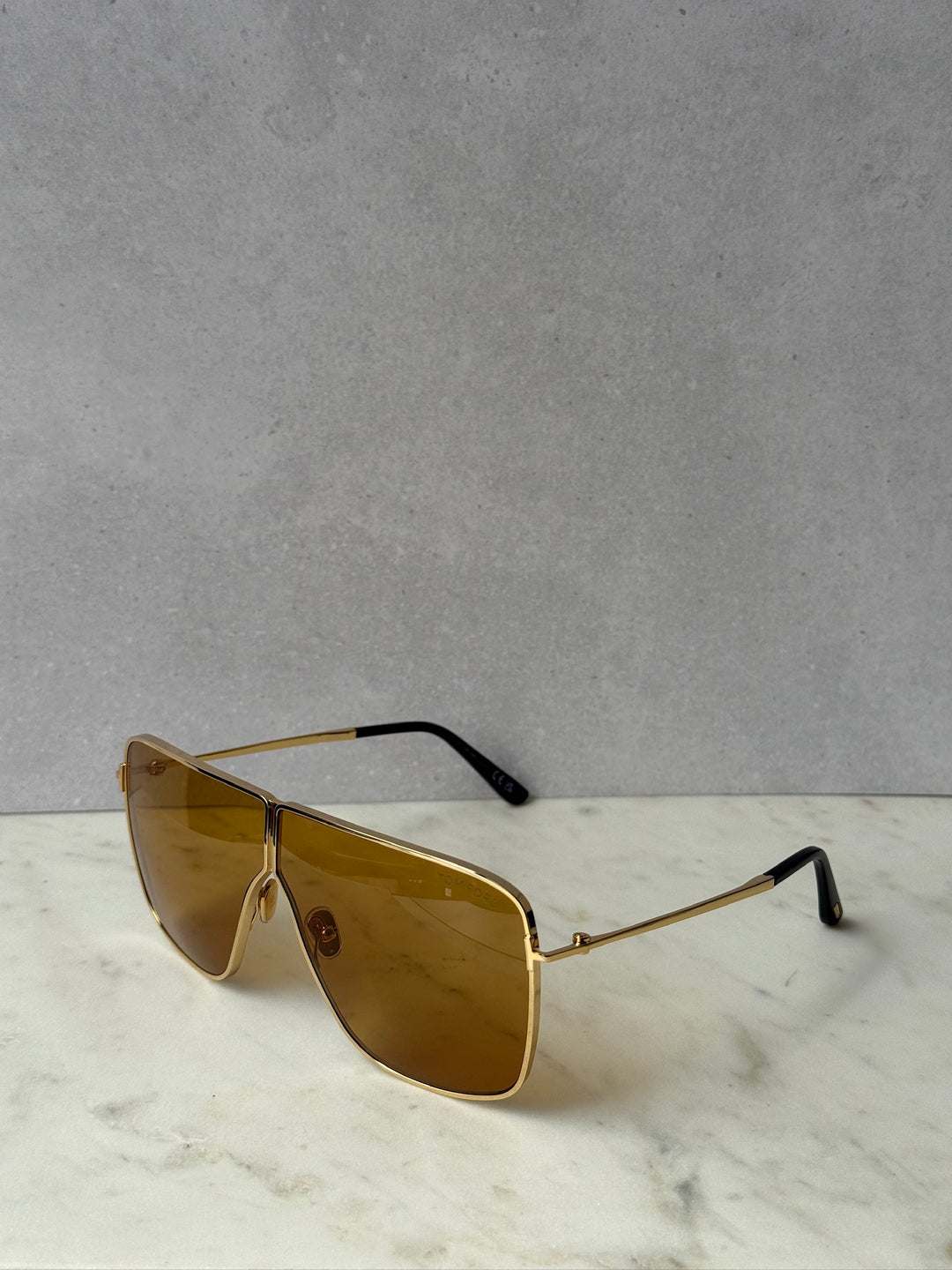 Gold square aviator sunglasses with amber lenses, side profile